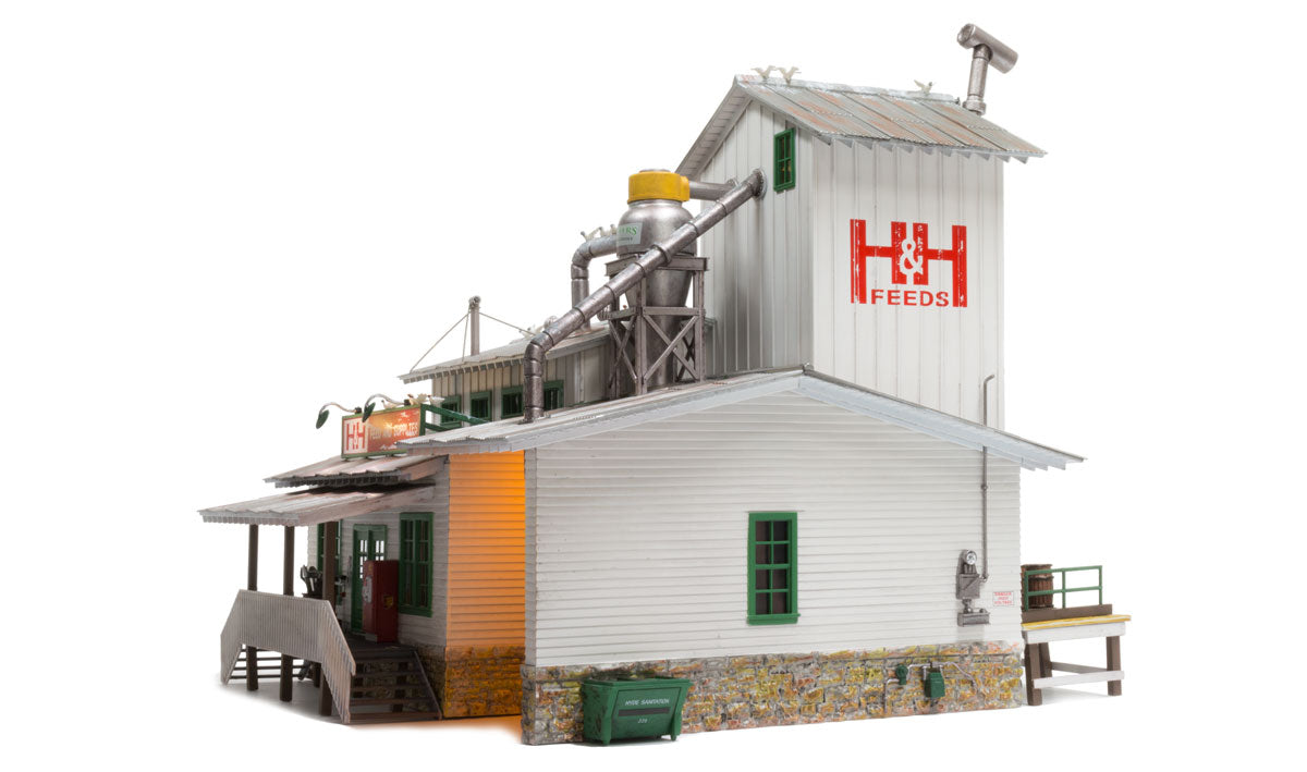 H&H Feed Mill O scale - side view with lit interior and grain cyclone